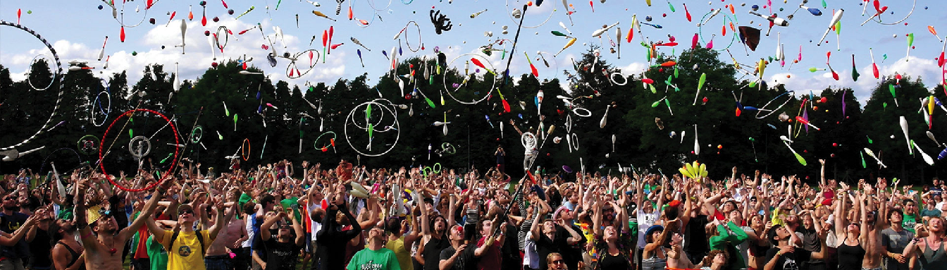 Crowd of people cheering and throwing hoops into the air